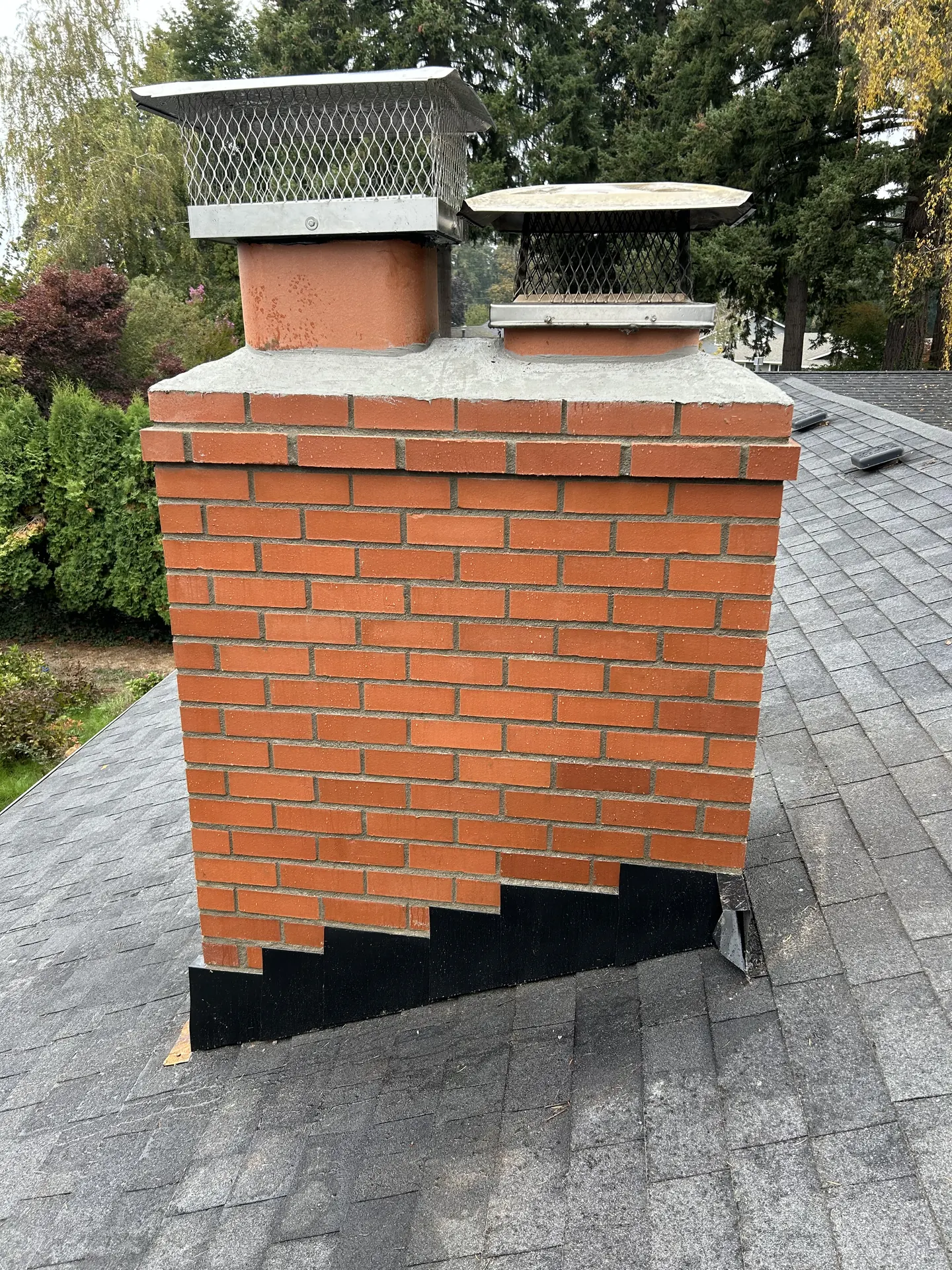 Chimney crown before and after: moss-eaten brick and rusted flashing, rebuilt with a poured crown and caps reset