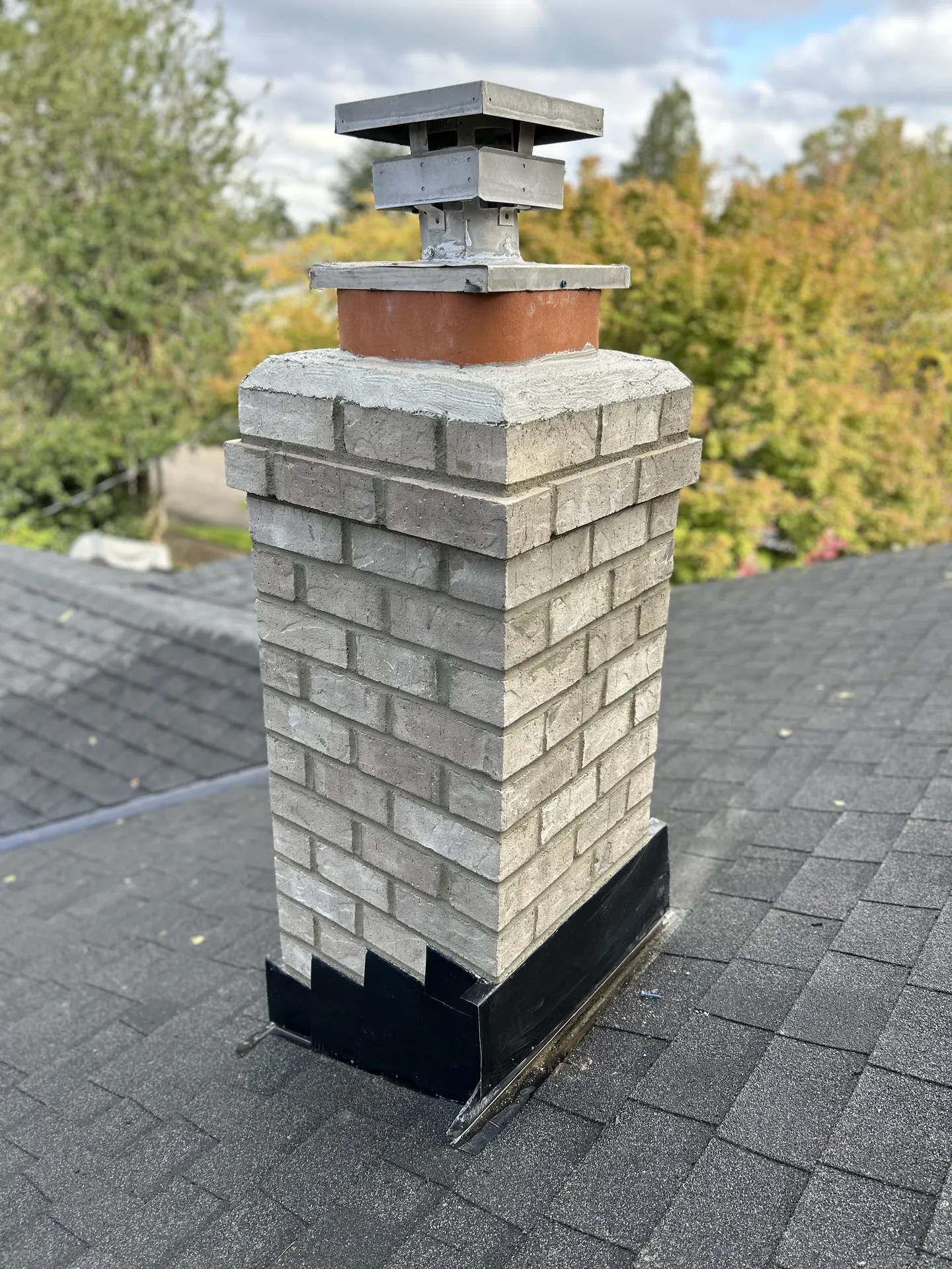 Fresh gray brick and crisp mortar lines on a First Rate Chimney rebuild